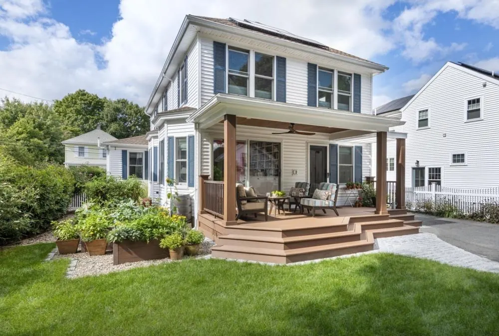 Finished rear deck and steps connecting the home to the yard by Lussoro Design + Build