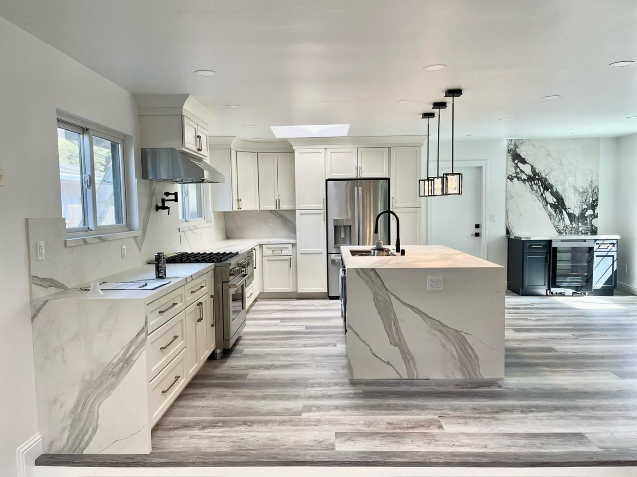 Modern kitchen remodel with marble waterfall island by Lussoro Design + Build