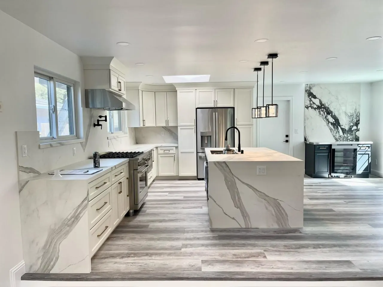 Modern kitchen remodel with marble waterfall island by Lussoro Design + Build