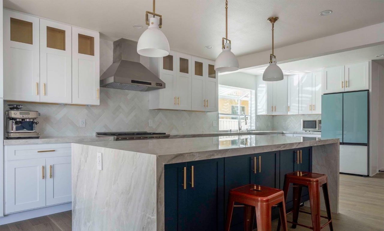 Navy and white kitchen remodel with marble countertops by Lussoro Design + Build