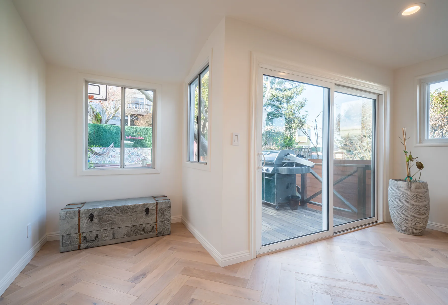 Bright dining nook with herringbone floors and garden access by Lussoro Design + Build