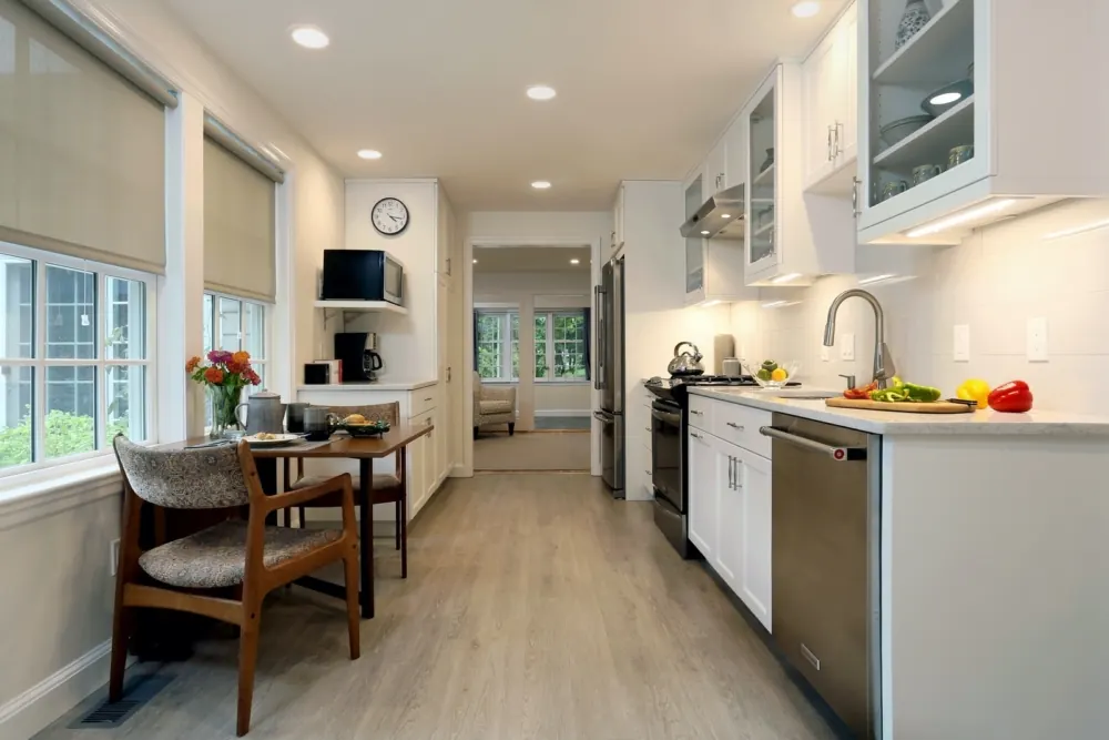 Converted garage studio with a full kitchenette, dining area, and flexible living space by Lussoro Design + Build
